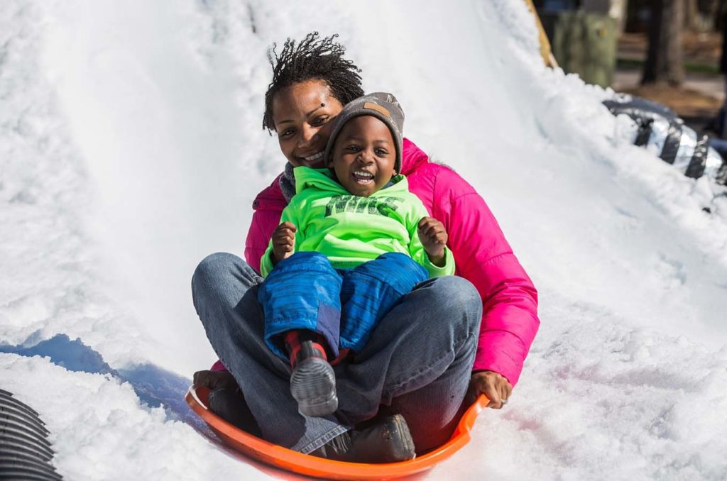 Mother and child sledding in the Lake Chelan snow