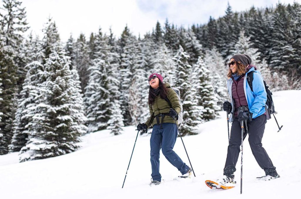 Two woman enjoying the snow while snowshoeing