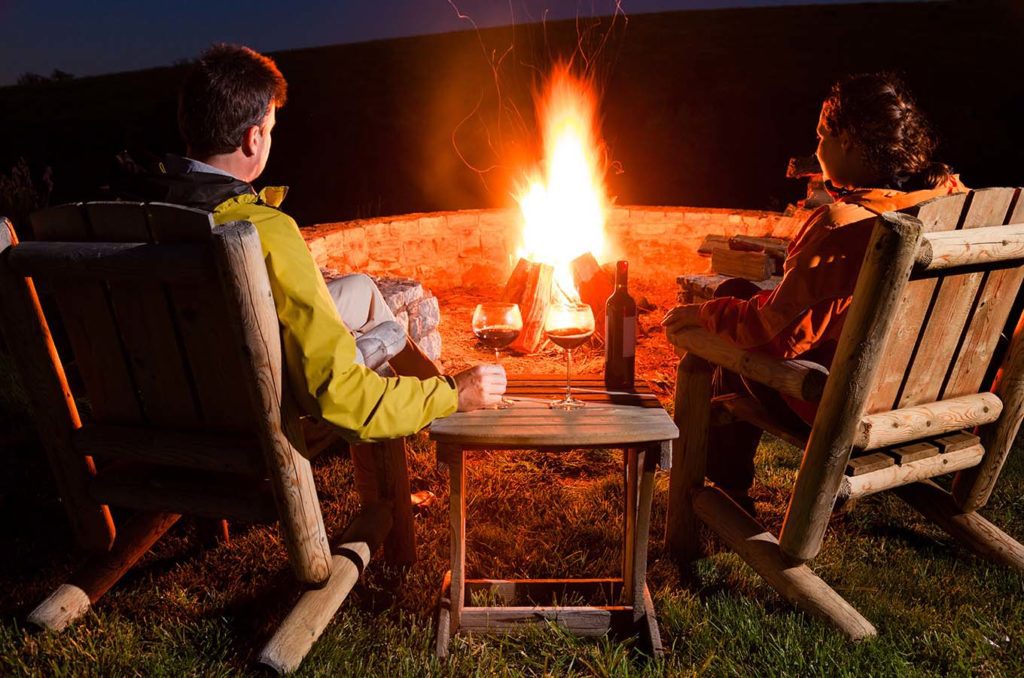 couple sitting around a bonfire