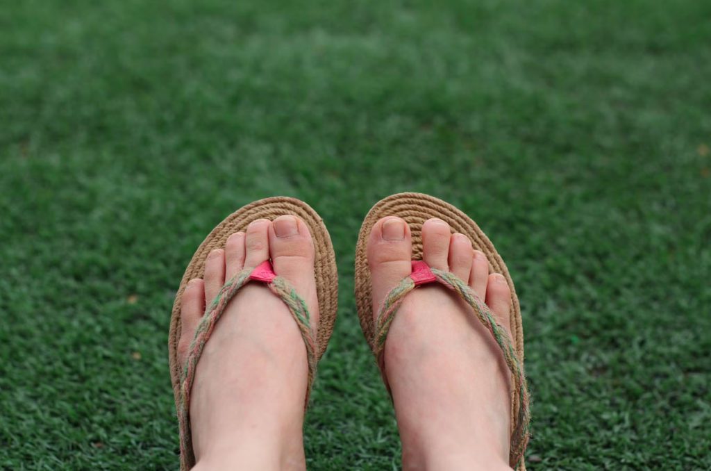Close up image of feet wearing flip flops