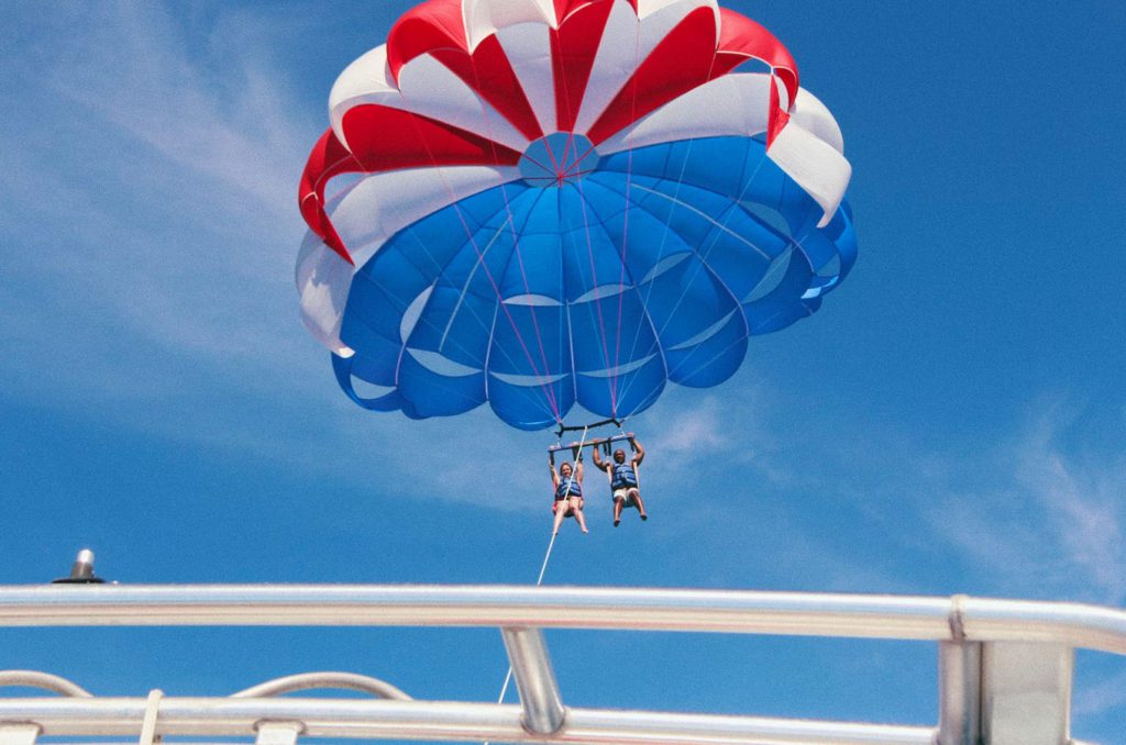 Two people tandem parasailing on the water of Lake Chelan during the day