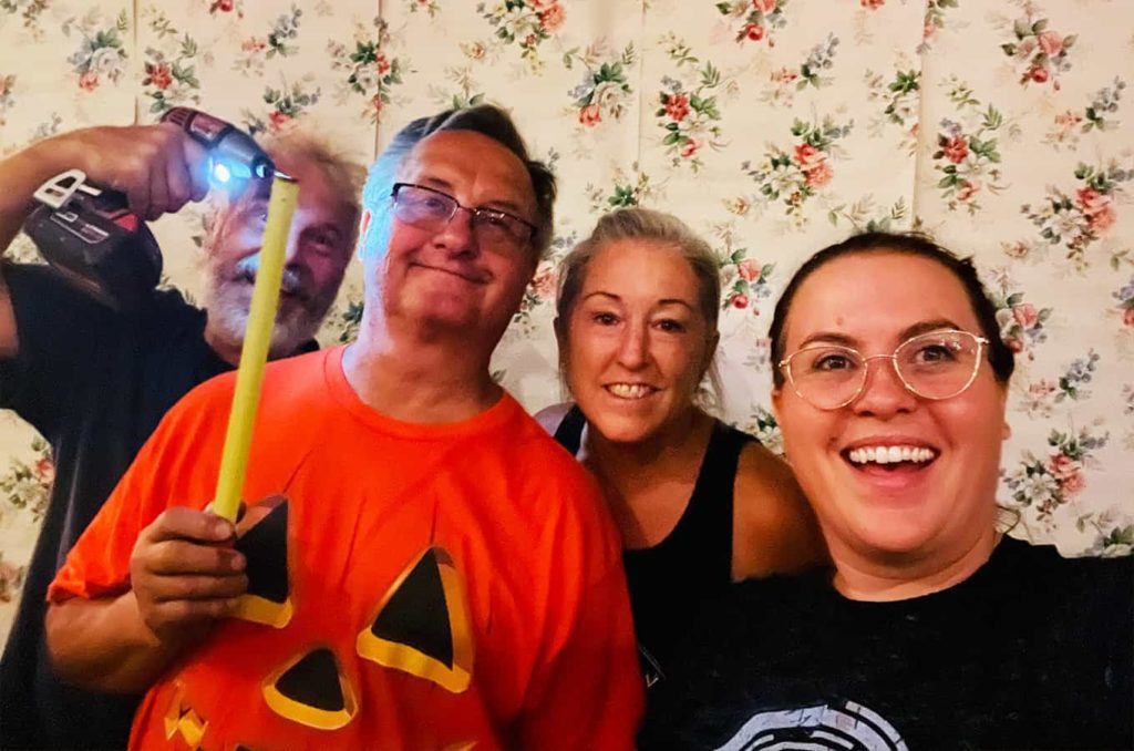 Group photo of four people working on the haunted house