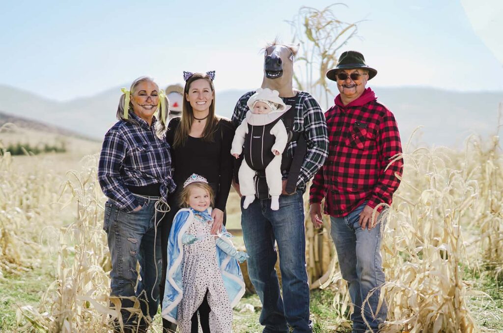 Kim and her family taking a Halloween portrait in a corn field